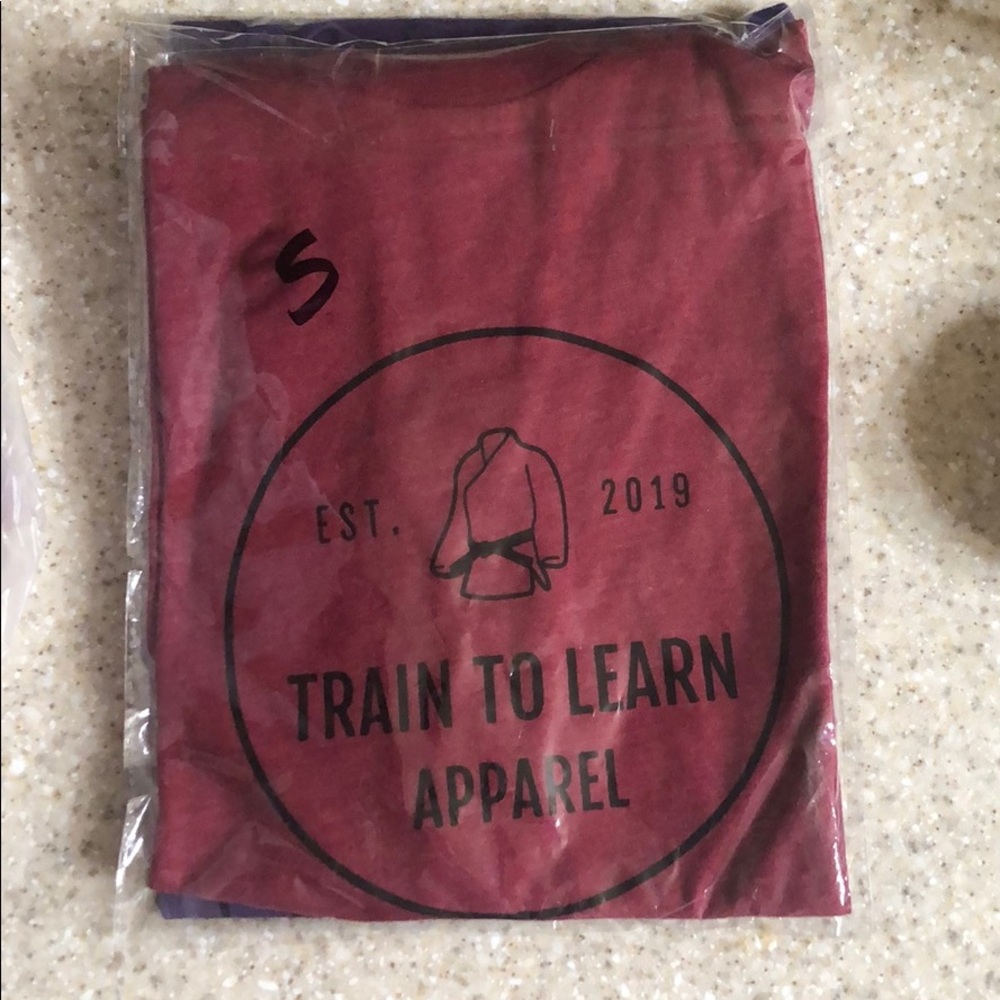 Train to learn apparel™️ next level T-shirt